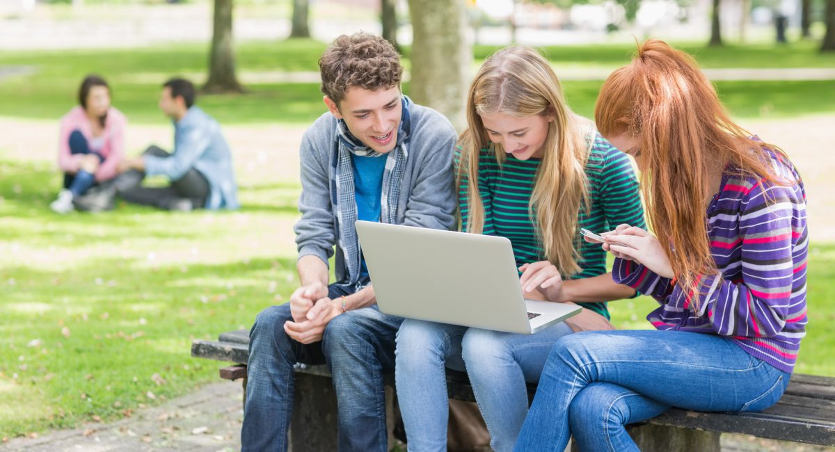 People outside on a laptop